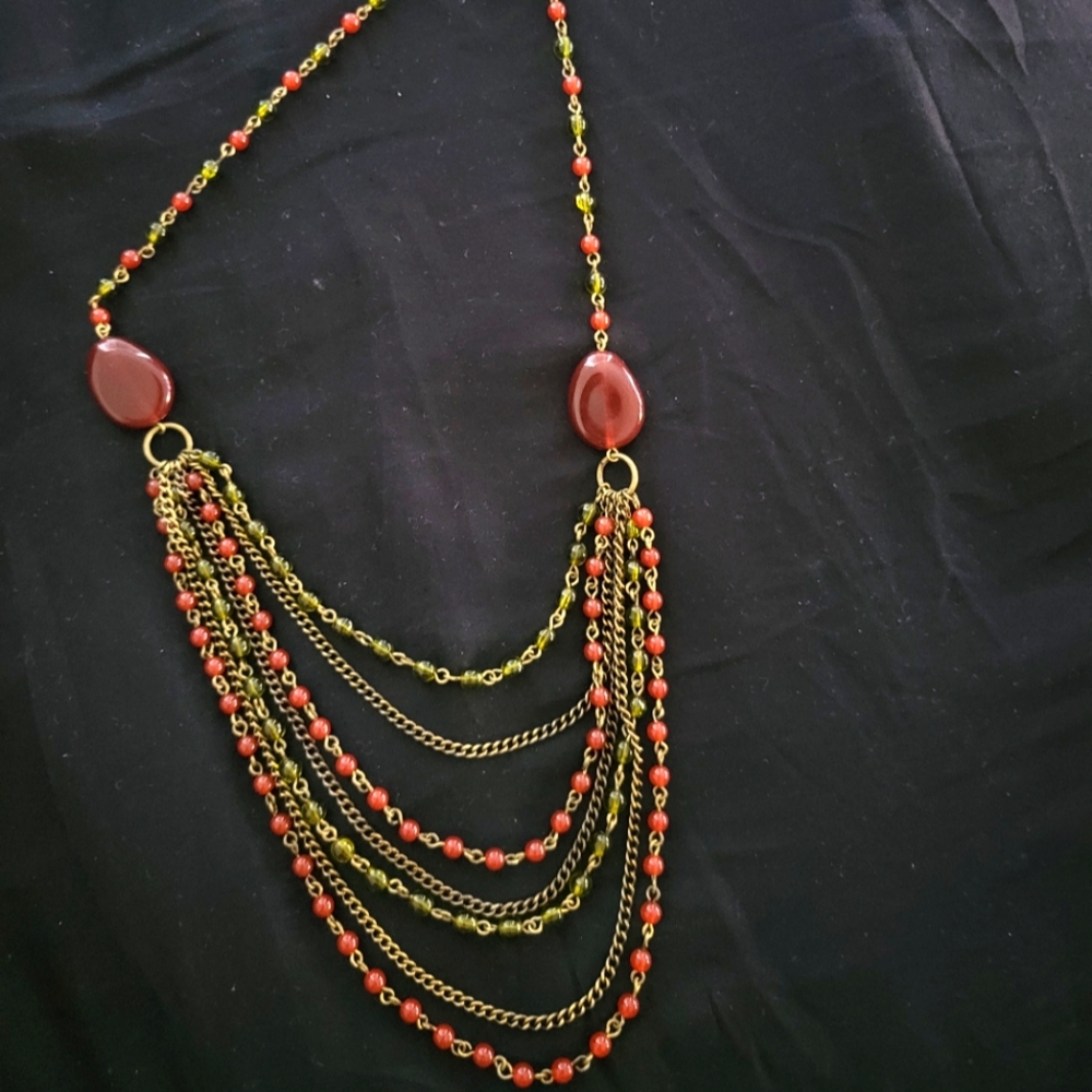 Avon multistrand necklace is goldtone and deep red
